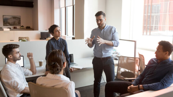 A business executive explaining duty of care policies to an employee before their business trip.